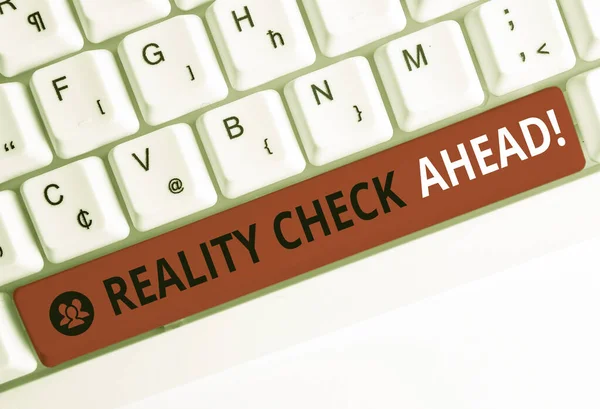 Writing note showing Reality Check Ahead. Business photo showcasing makes them recognize truth about situations or difficulties White pc keyboard with note paper above the white background. — Stock Photo, Image