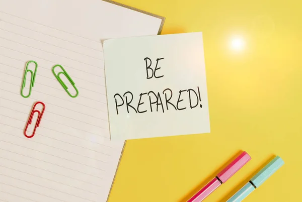 Word writing text Be Prepared. Business concept for try be always ready to do or deal with something Empty blue paper with copy space paper clips and pencils on the yellow table. — Stock Photo, Image