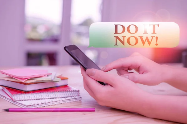 Writing note showing Do It Now. Business photo showcasing not hesitate and start working or doing stuff right away woman using smartphone and technological devices inside the home.