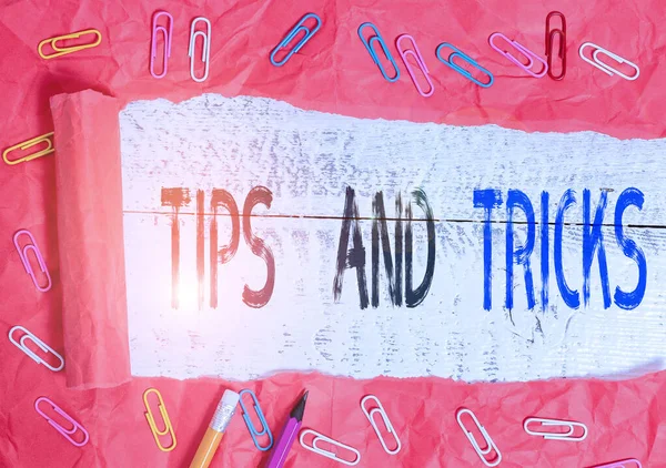 Handwriting text writing Tips And Tricks. Concept meaning means piece advice maybe suggestion how improve Stationary and torn cardboard placed above a wooden classic table backdrop.