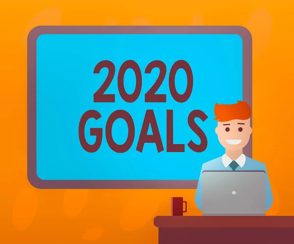 Writing note showing 2020 Goals. Business photo showcasing a targeted list of ambitions that need to be fulfilled in a year Bordered Board behind Man Sitting Smiling with Laptop Mug on Desk.