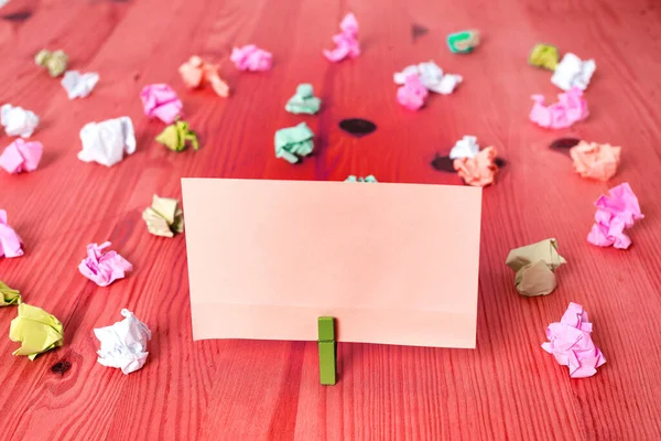 Rettangolo quadrato a forma di carta colorata con molletta o palla di carta in uno sfondo chiaro. Diffusione variopinta della nota stropicciata intorno al tavolo. Forniture per ufficio in una scrivania . — Foto Stock