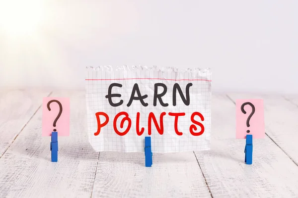 Conceptual hand writing showing Earn Points. Business photo showcasing a fund rewarded automatically after purchasing any product Crumbling sheet with paper clips placed on the wooden table.