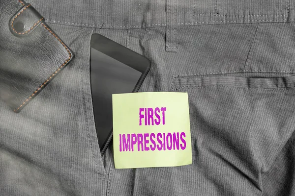 Word writing text First Impressions. Business concept for events when one an individual encounters another an individual Smartphone device inside trousers front pocket with wallet and note paper.