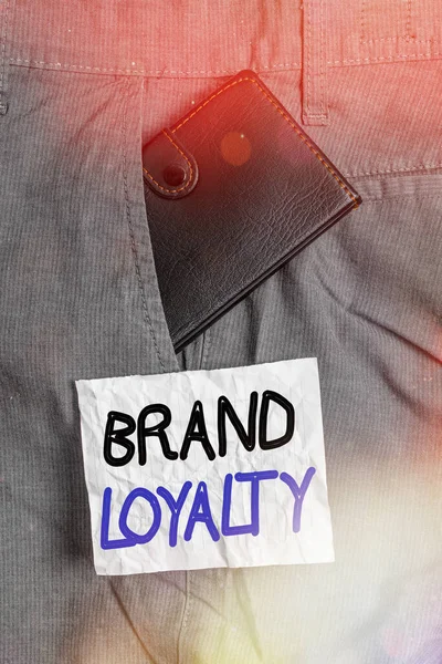 Text sign showing Brand Loyalty. Conceptual photo positive feelings to a brand and purchase the same product Small little wallet inside man trousers front pocket near notation paper.