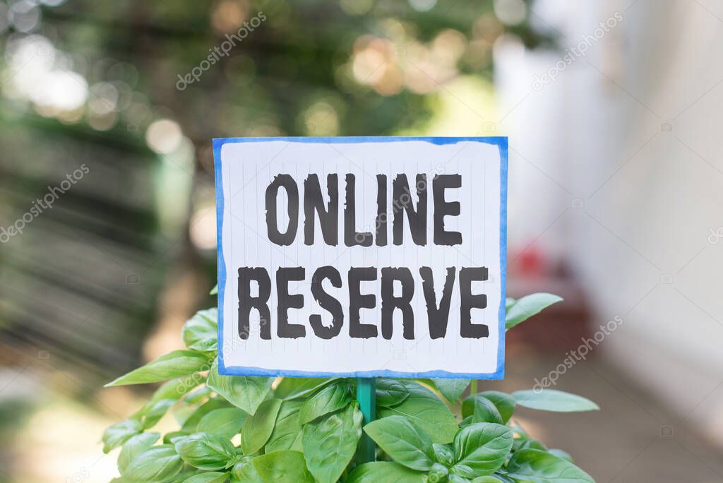 Writing note showing Online Reserve. Business photo showcasing enables the customers to book by checking availability Plain paper attached to stick and placed in the grassy land.