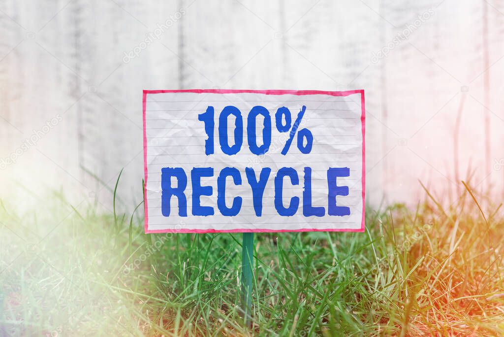 Text sign showing 100 Percent Recycle. Conceptual photo Set of Biodegradable, BPA free and compostable recyclable Crumpled paper attached to a stick and placed in the green grassy land.