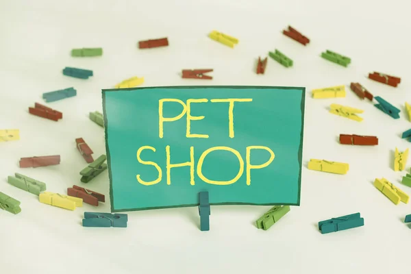 Word writing text Pet Shop. Business concept for a retail business concentrating on selling domesticated animals Colored clothespin papers empty reminder white floor background office. — Stock Photo, Image