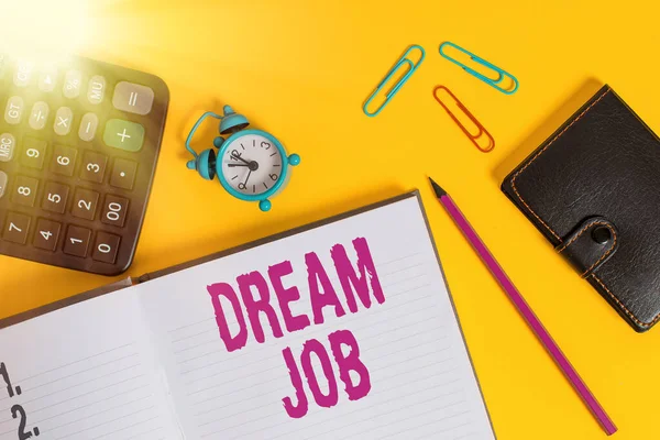 Handwriting text Dream Job. Concept meaning the professional career that an individual is working hard to earn it Open notebook wallet calculator clips pencil alarm clock color background.