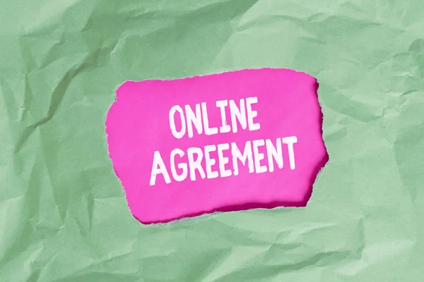 Word writing text Online Agreement. Business concept for contracts that are created and signed over the Internet Green crumpled ripped colored paper sheet centre torn colorful background.