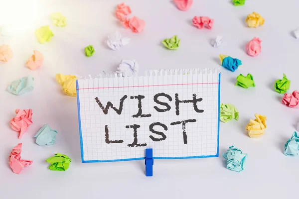 Word writing text Wish List. Business concept for a composition of desired objects but often unrealistically Colored crumpled papers empty reminder white floor background clothespin.