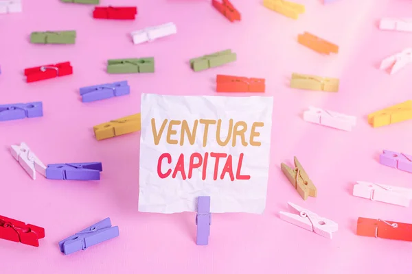Writing note showing Venture Capital. Business photo showcasing available for investment in the ownership element of new Colored clothespin papers empty reminder pink floor office pin.