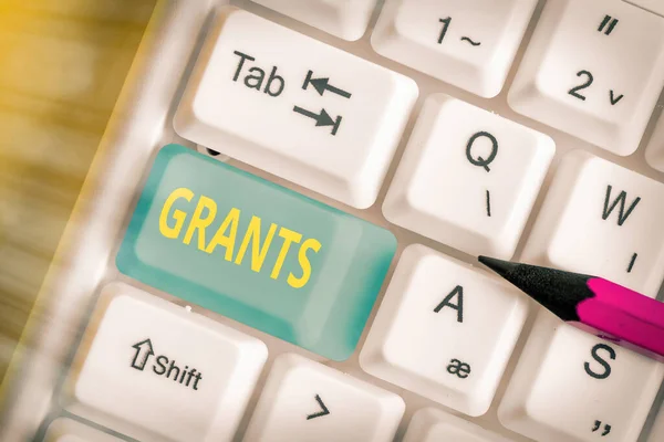 Writing note showing Grants. Business photo showcasing nonrepayable funds or products disbursed or given by one party.