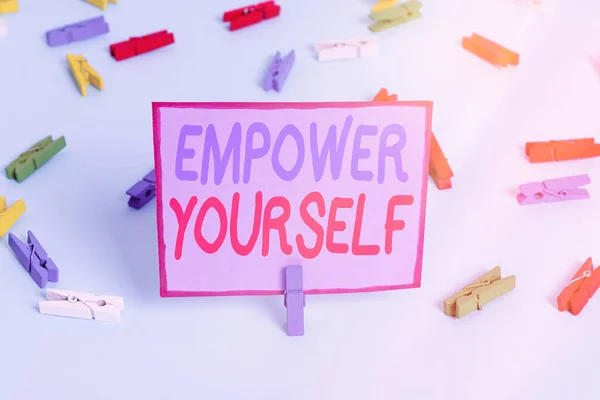 Writing note showing Empower Yourself. Business photo showcasing giving you the power to take control of your own destiny Colored clothespin papers empty reminder blue floor officepin. — Stock Photo, Image