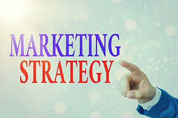 Writing note showing Marketing Strategy. Business photo showcasing plan of action designed to promote and sell product. — Stock Photo, Image