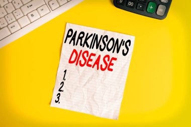 Parkinson hastalığını gösteren kavramsal el yazısı. Sonraki hayatın kronik ilerici nörolojik hastalığını gösteren iş fotoğrafı masadaki bilgisayar klavyesiyle alanı kopyala.