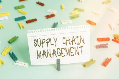 Tedarik Zinciri Yönetimini gösteren not yazılıyor. Modern akıllı şirket lojistik işlemlerinin görüntülerini gösteren iş fotoğrafı. Renkli çamaşır iğnesi kağıtları. Boş hatırlatma mavi zemin ofisi..