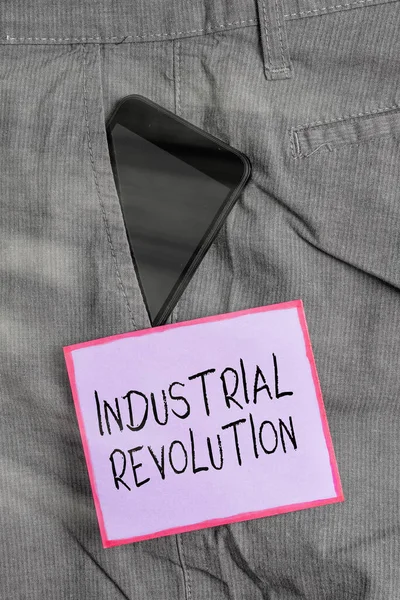 Text sign showing Industrial Revolution. Conceptual photo changes in manufacturing and transportation goods Smartphone device inside formal work trousers front pocket near note paper. — Stock Photo, Image