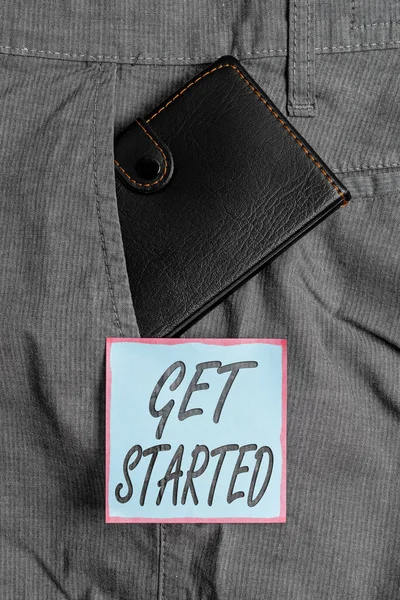 Writing note showing Get Started. Business photo showcasing to begin accomplishing or working on the tasks to finish it Small wallet inside trouser front pocket near notation paper. — Stock Photo, Image