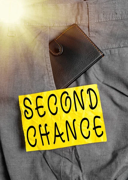 Word writing text Second Chance. Business concept for the opportunity given to someone, allows them to try again Small little wallet inside man trousers front pocket near notation paper.