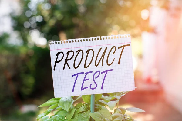 Text sign showing Product Test. Conceptual photo process of measuring the properties or performance of products Plain empty paper attached to a stick and placed in the green leafy plants.