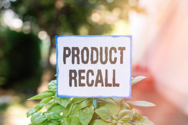 Writing note showing Product Recall. Business photo showcasing request to return the possible product issues to the market Plain paper attached to stick and placed in the grassy land. clipart