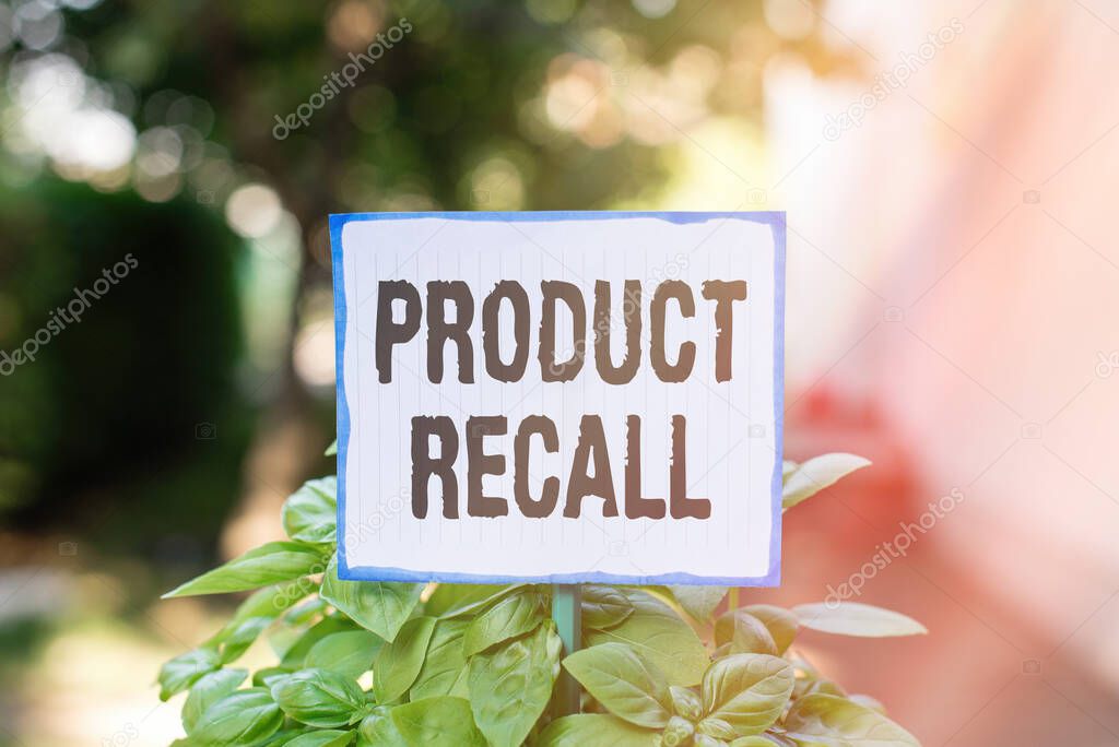 Writing note showing Product Recall. Business photo showcasing request to return the possible product issues to the market Plain paper attached to stick and placed in the grassy land.