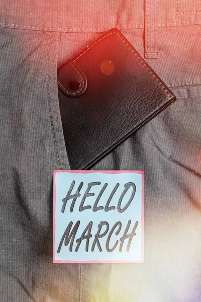 Escribiendo nota mostrando Hello March. Foto de negocios que muestra una expresión de saludo utilizada al dar la bienvenida al mes de marzo Cartera pequeña dentro del bolsillo delantero del pantalón cerca del papel de notación . —  Fotos de Stock