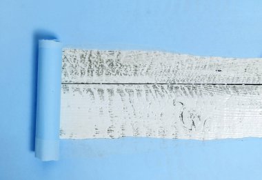 Çalar saati ve çivileri ahşap masanın üzerine yerleştirilmiş rulo şeklinde sökülmüş karton. Ahşap bir zemindeki kalın yırtık kağıt. Flat Lays Fotoğrafçılığı Düzenleme Sanatsal Yolu