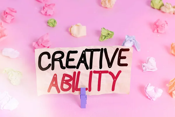 Writing note showing Creative Ability. Business photo showcasing power to act freely to show themselves without limitation Colored crumpled papers empty reminder pink floor background clothespin.