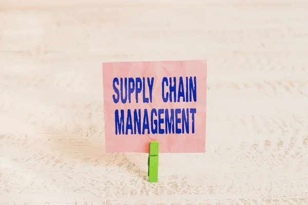 Handwriting text Supply Chain Management. Concept meaning Aspects of modern smart company logistics processes Green clothespin white wood background colored paper reminder office supply.
