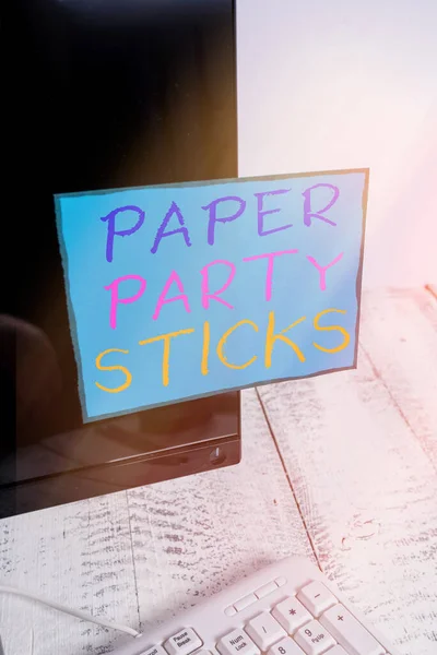 Word writing text Paper Party Sticks. Business concept for hard painted paper shaped used for signs and emoji Notation paper taped to black computer monitor screen near white keyboard.