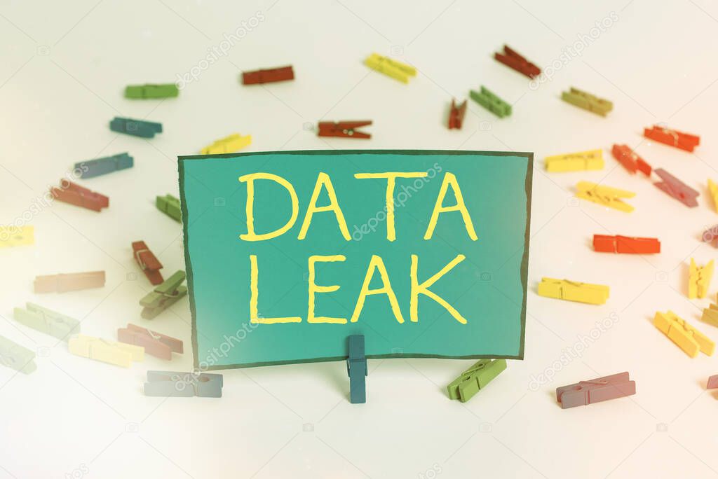 Word writing text Data Leak. Business concept for released illegal transmission of data from a company externally Colored clothespin papers empty reminder white floor background office.