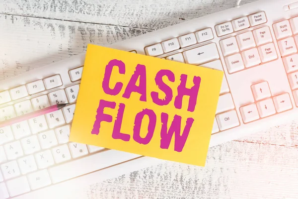 Text sign showing Cash Flow. Conceptual photo auditing the net amount of cash transferred into and onto the business White keyboard office supplies empty rectangle shaped paper reminder wood.