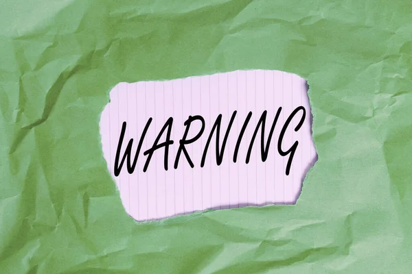 Writing note showing Warning. Business photo showcasing statement or event that indicates a possible or impending danger Green crumpled colored paper sheet torn colorful background. — Stock Photo, Image