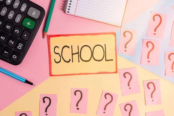 Text sign showing School. Conceptual photo designed to provide learning spaces and learning environments Mathematics stuff and writing equipment above pastel colours background.