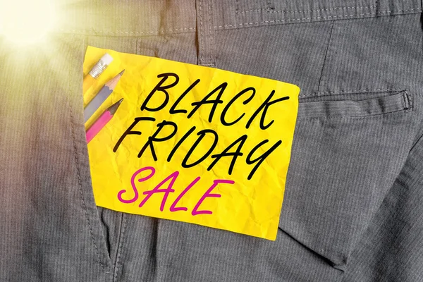 Word writing text Black Friday Sale. Business concept for Attract the buyers with Exclusive product s is lower price Writing equipment and yellow note paper inside pocket of man work trousers.
