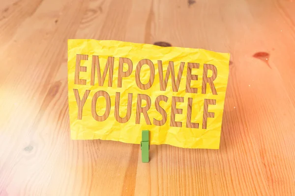 Conceptual hand writing showing Empower Yourself. Business photo text giving you the power to take control of your own destiny Wooden floor background green clothespin groove slot office. — Stock Photo, Image