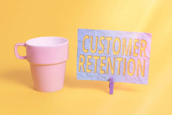 Handwriting text Customer Retention. Concept meaning activities companies take to reduce user defections Cup empty paper blue clothespin rectangle shaped reminder yellow office.