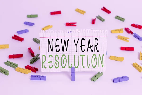 Writing note showing New Year Resolution. Business photo showcasing listing of goals and change with determination Colored clothespin papers empty reminder white floor background office. — Stock Photo, Image