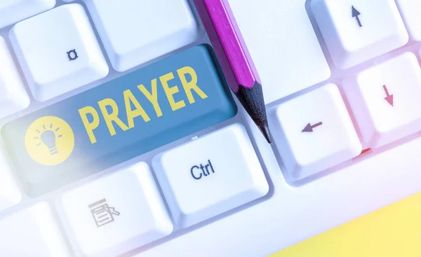 Word writing text Prayer. Business concept for solemn request for help or expression of thanks addressed to God White pc keyboard with empty note paper above white key copy space. — Stock Photo, Image