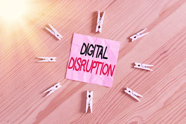 Writing note showing Digital Disruption. Business photo showcasing occur when technologies affect value proposition of goods Colored clothespin papers empty reminder wooden floor background office.