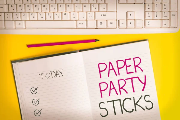 Writing note showing Paper Party Sticks. Business photo showcasing hard painted paper shaped used for signs and emoji Copy space on notebook above yellow background with keyboard on table.