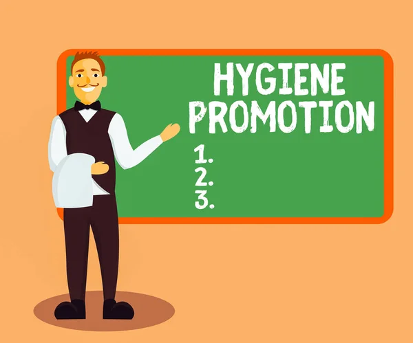 Handschriftlicher Text Hygiene Promotion. Konzept bedeutet systematisches Programm zur Vorbeugung von Krankheiten mit Hygiene Männlicher Kellner lächelt in einheitlicher Hand und präsentiert leere Menütafel. — Stockfoto