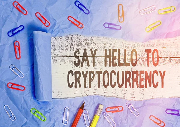 Handwriting text writing Say Hello To Cryptocurrency. Concept meaning Lead and advertise decentralized money exchange Rolled ripped torn cardboard placed above a wooden classic table backdrop.