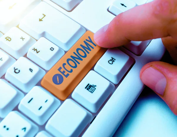 Writing note showing Economy. Business photo showcasing the system of how money is made and used within a particular country White pc keyboard with empty note paper above white key copy space. — Stock Photo, Image