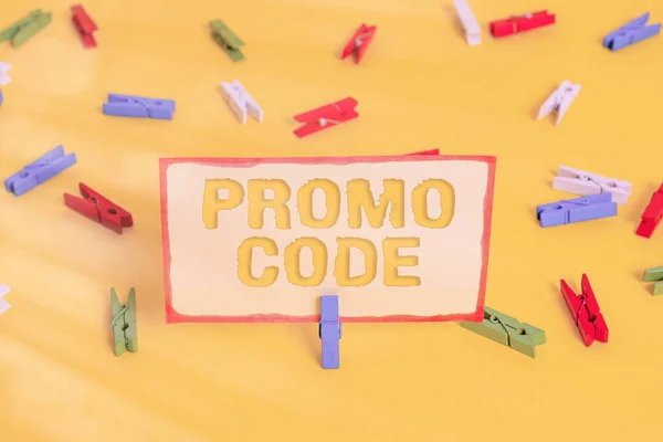 Conceptual hand writing showing Promo Code. Business photo text letters or numbers that allows getting a discount on something Colored clothespin papers empty reminder yellow floor office.