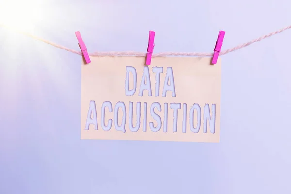 Word writing text Data Acquisition. Business concept for way to obtain statistics that can be maneuvered digitally Clothesline clothespin rectangle shaped paper reminder white wood desk.