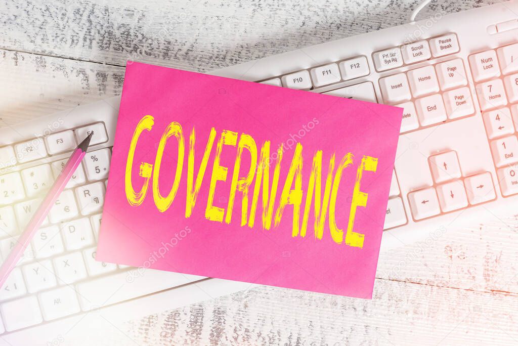 Handwriting text writing Governance. Concept meaning exercised in handling an economic situation in a nation White keyboard office supplies empty rectangle shaped paper reminder wood.