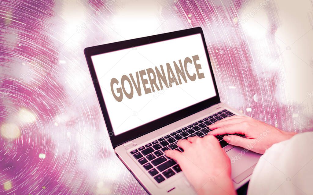 Handwriting text writing Governance. Concept meaning exercised in handling an economic situation in a nation Modern gadgets with white display screen under colorful bokeh background.